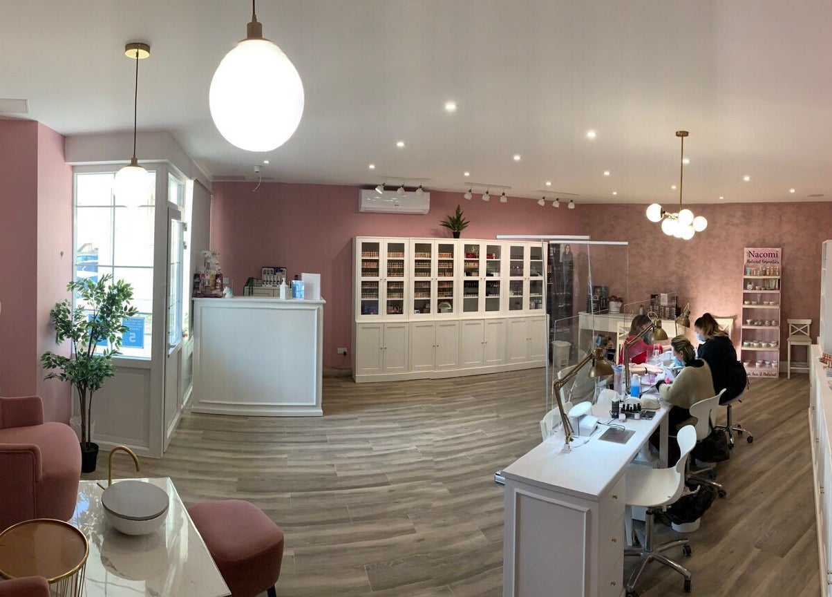 Modern and cozy interior of Total Beauty Malta in Ħal Luqa, MT, featuring elegant pink decor and inviting seating.