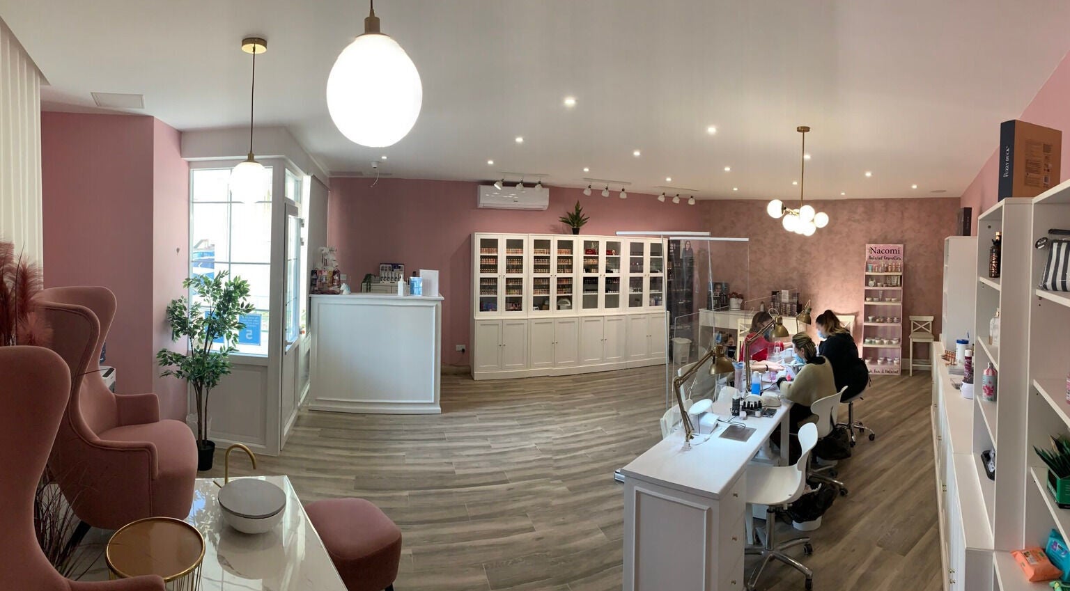 Modern and cozy interior of Total Beauty Malta in Ħal Luqa, MT, featuring elegant pink decor and inviting seating.