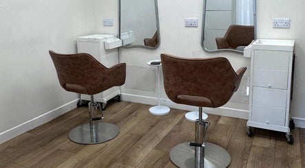 Salon interior at Kolours Beauty Bar, Edinburgh, Scotland, GB featuring stylish brown chairs and mirrors.