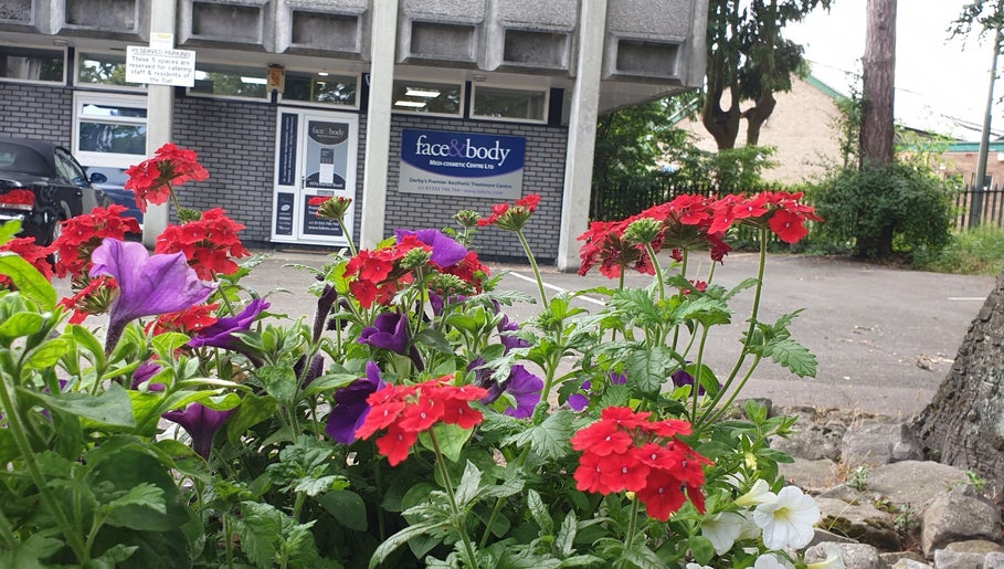 Face & Body Medi-cosmetic Centre entrance with vibrant flowers in Derby, England, GB.