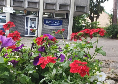 Face & Body Medi-cosmetic Centre entrance with vibrant flowers in Derby, England, GB.