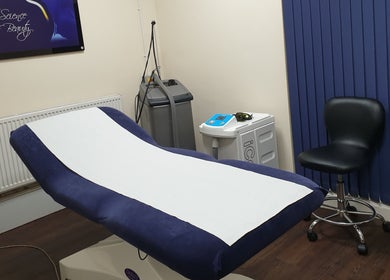 Comfortable treatment room at Face & Body Medi-cosmetic Centre, Derby, England, GB, featuring a treatment bed.