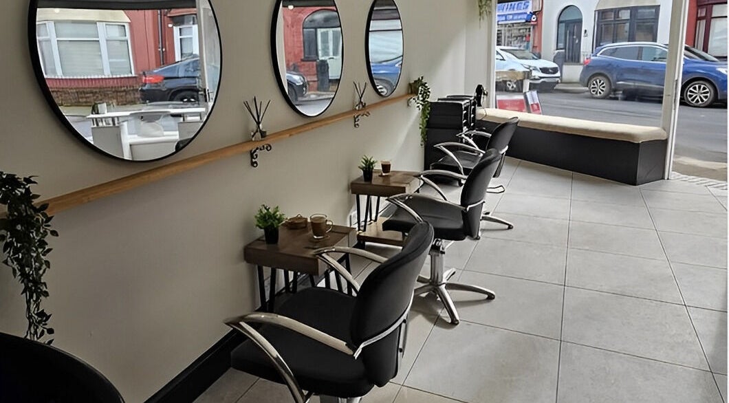 Sleek, modern styling area at Lashes By Fayedavies, Waterloo, England, GB showcasing elegant mirrors and chairs.
