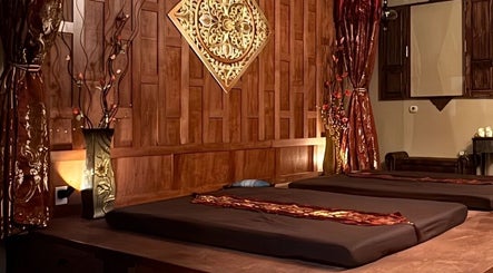 Elegant massage room at Thai Euphorea Spa & Massage, Las Vegas, Nevada, US with calming decor and ambient lighting.