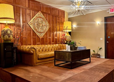 Elegant seating area at Thai Euphorea Spa & Massage, Las Vegas, Nevada, US featuring a classic brown leather sofa.
