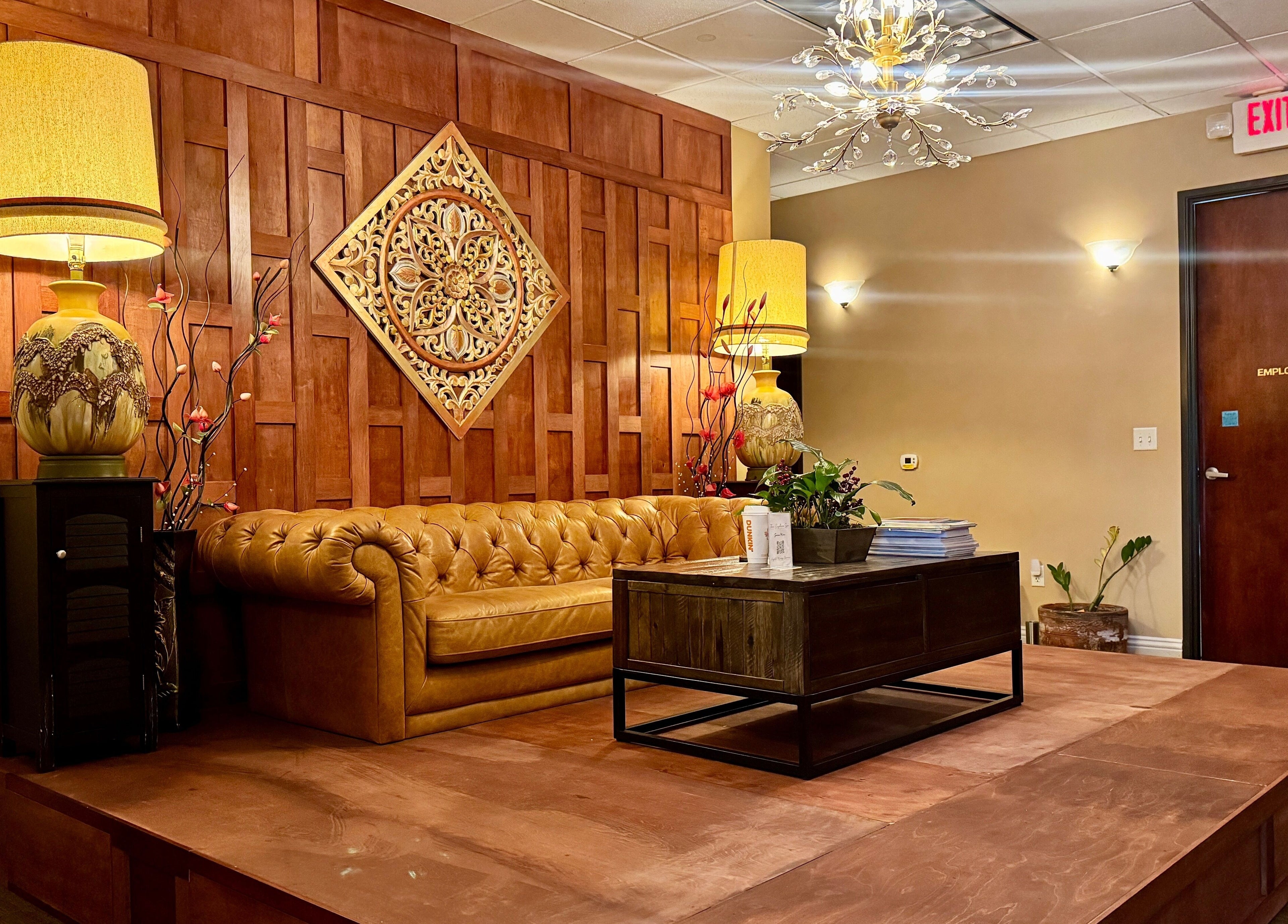 Elegant seating area at Thai Euphorea Spa & Massage, Las Vegas, Nevada, US featuring a classic brown leather sofa.