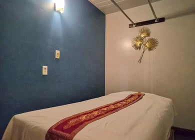 Relaxing massage room at Chiang Mai Thai Spa in Las Vegas, Nevada, US, featuring a cozy bed and warm lighting.