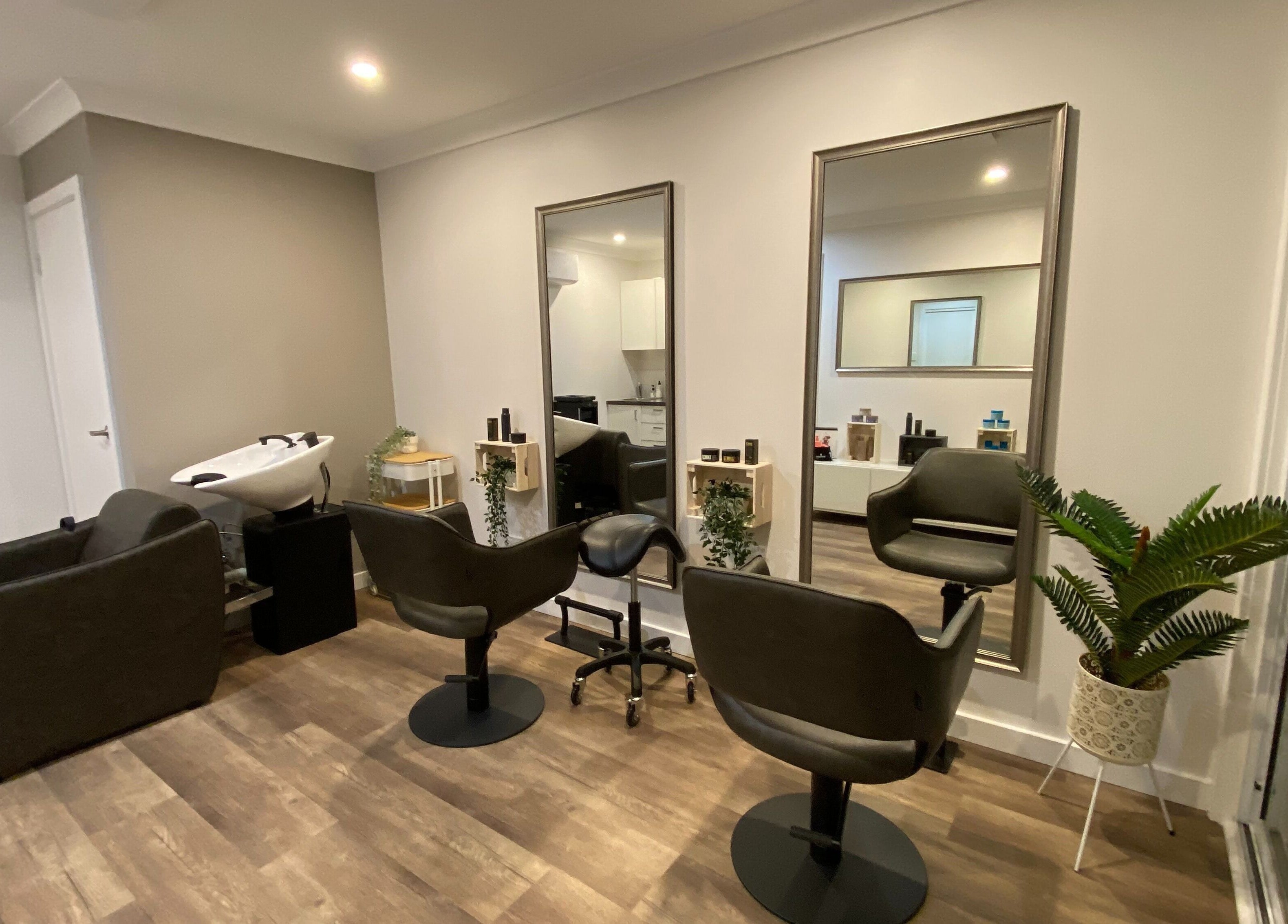 Elegant salon setup at Hair at HQ in Menai, New South Wales, AU with styling chairs and mirrors.