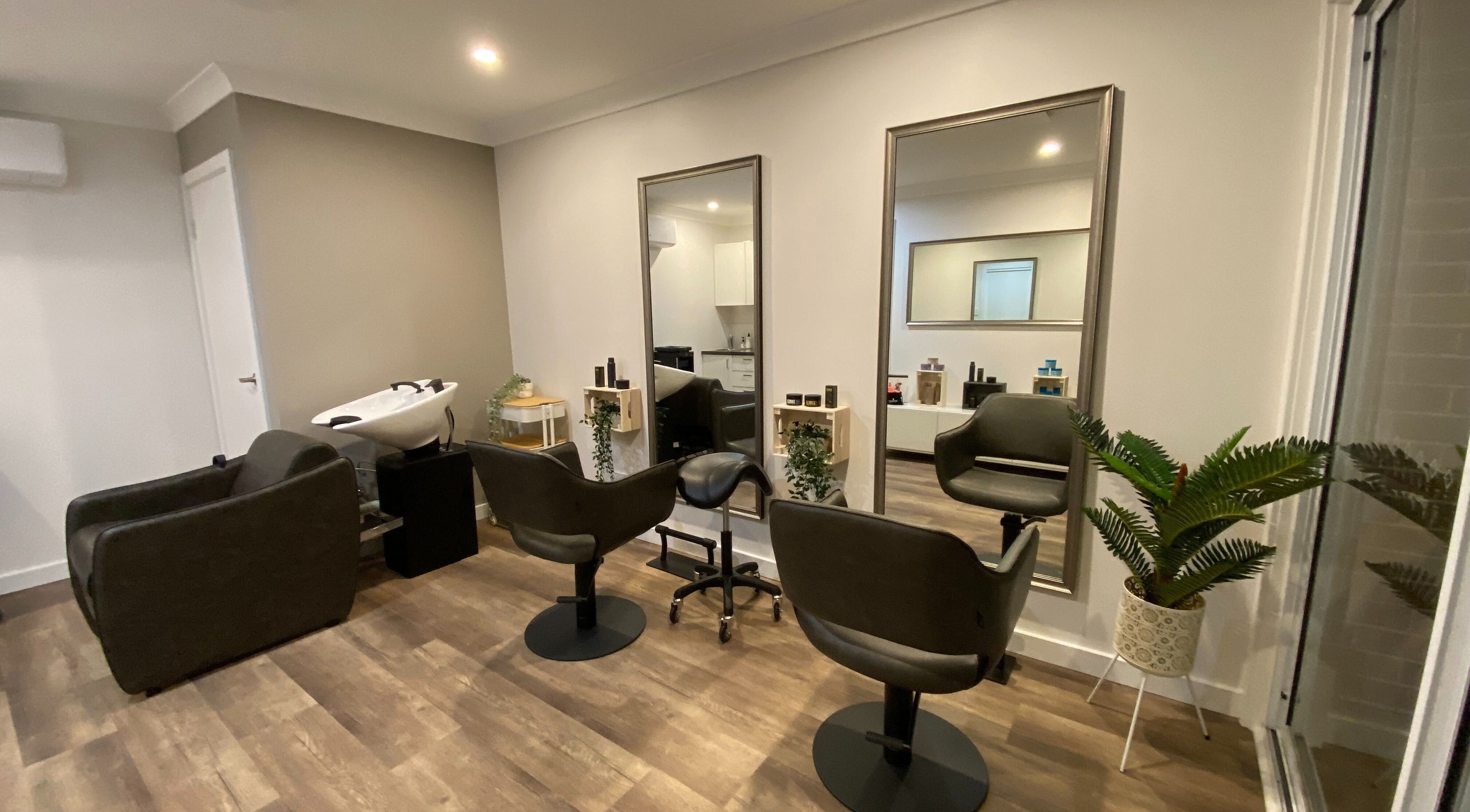 Elegant salon setup at Hair at HQ in Menai, New South Wales, AU with styling chairs and mirrors.