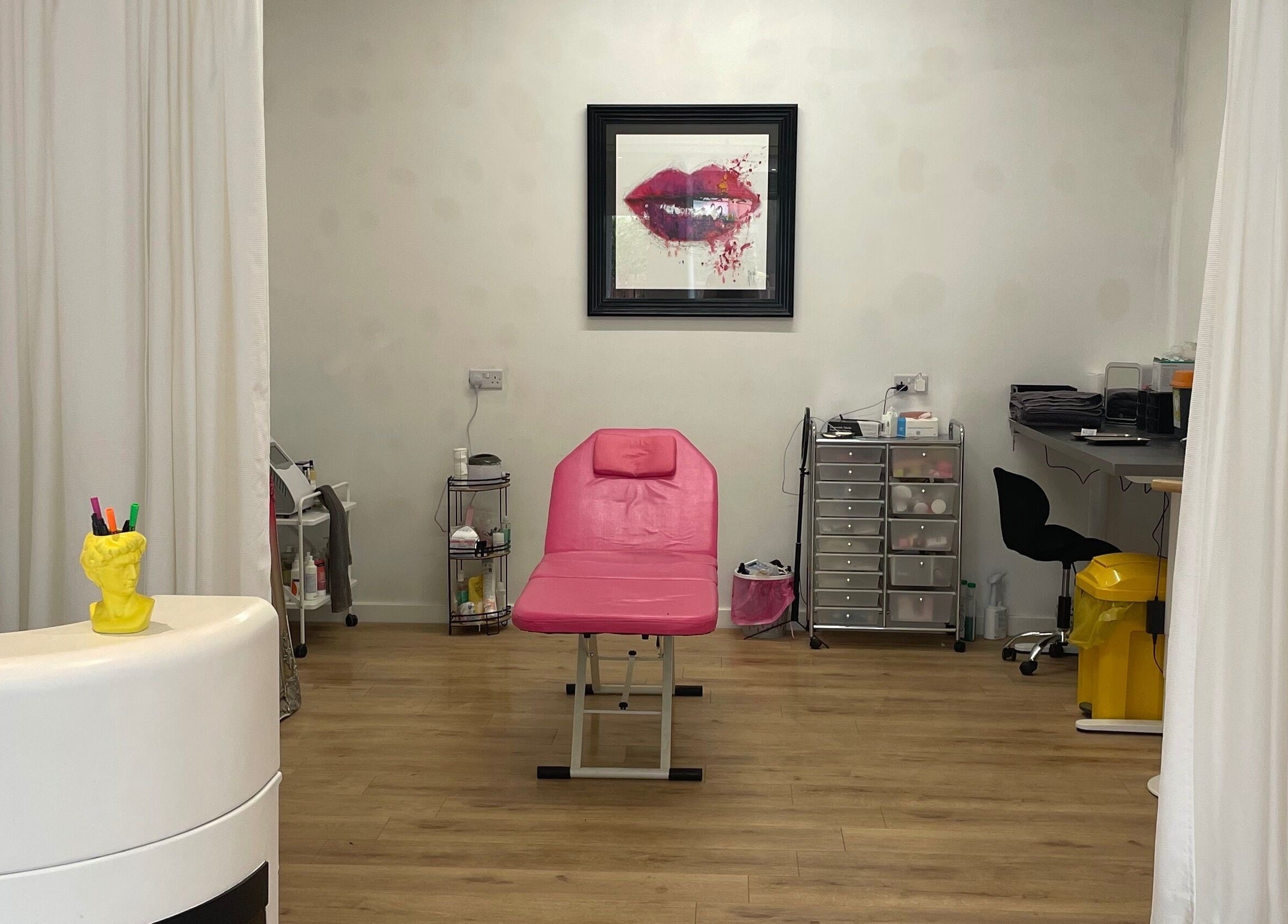 Beauty Junkie treatment room in Jarrow, England features a pink bed and stylish decor.