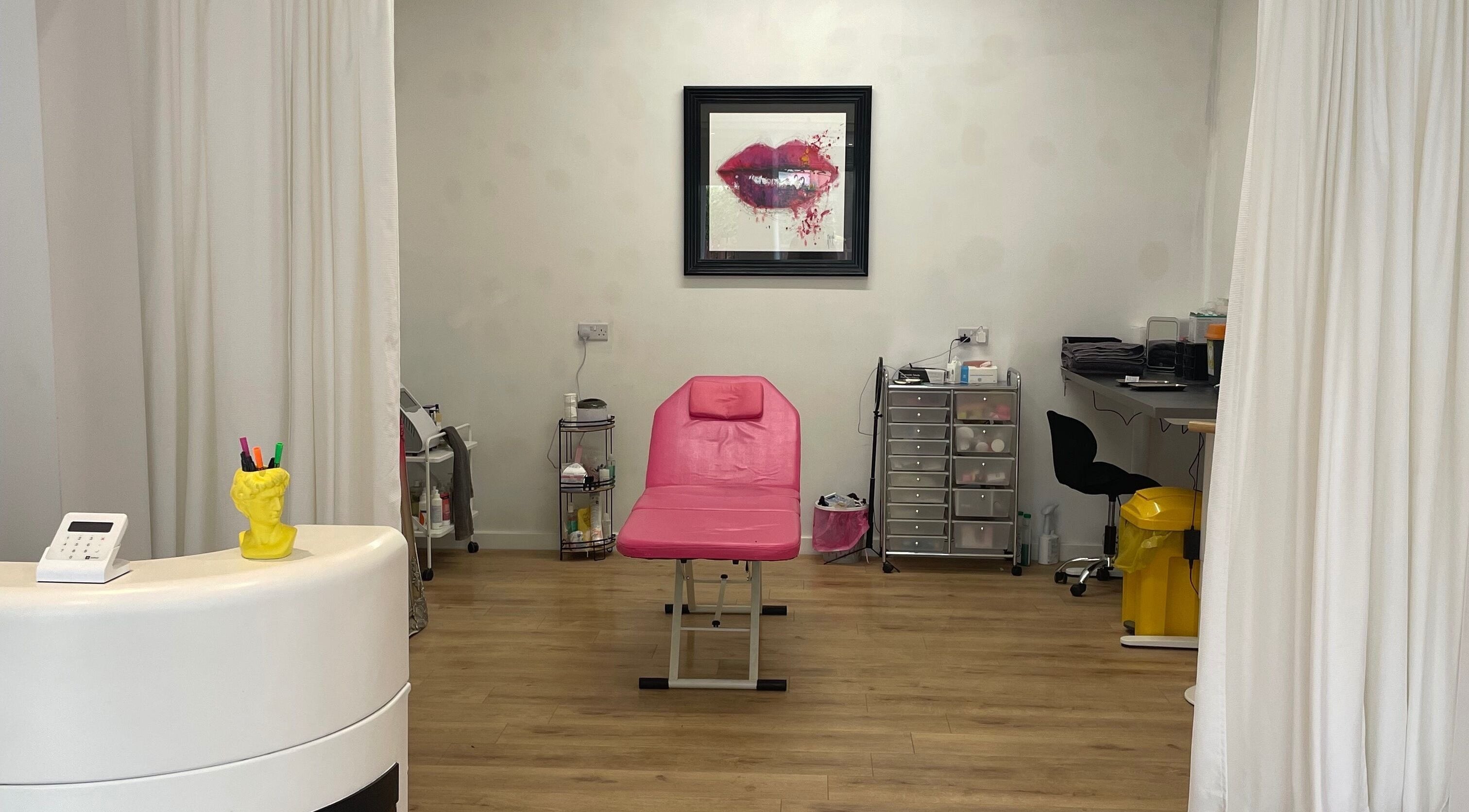 Beauty Junkie treatment room in Jarrow, England features a pink bed and stylish decor.
