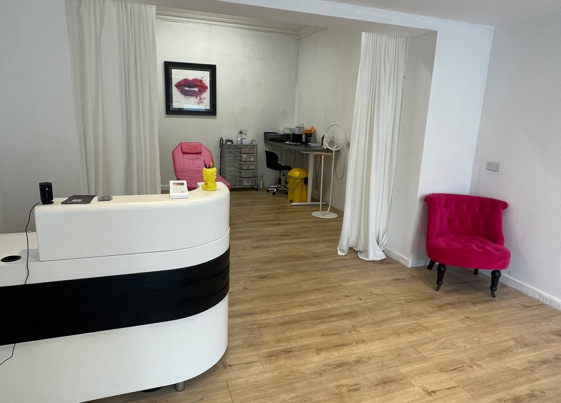 Reception area of Beauty Junkie, Jarrow, England with modern decor and cozy seating.