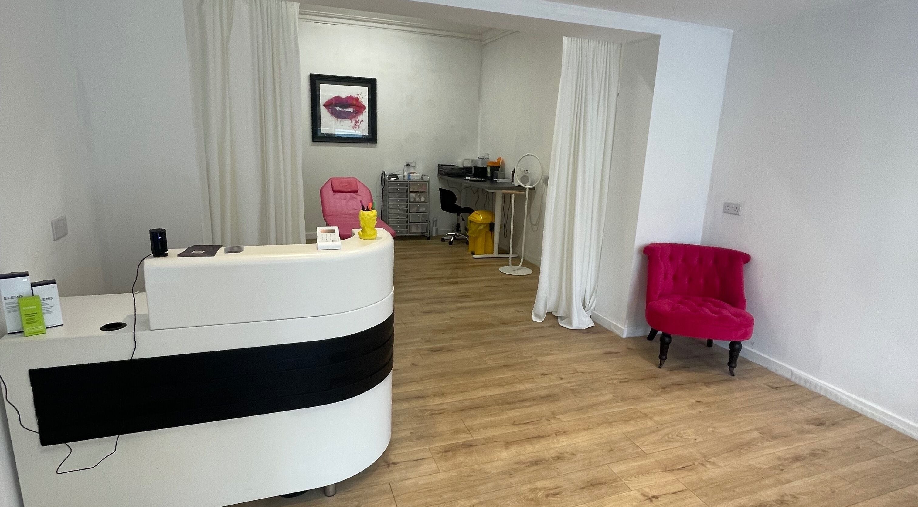 Reception area of Beauty Junkie, Jarrow, England with modern decor and cozy seating.