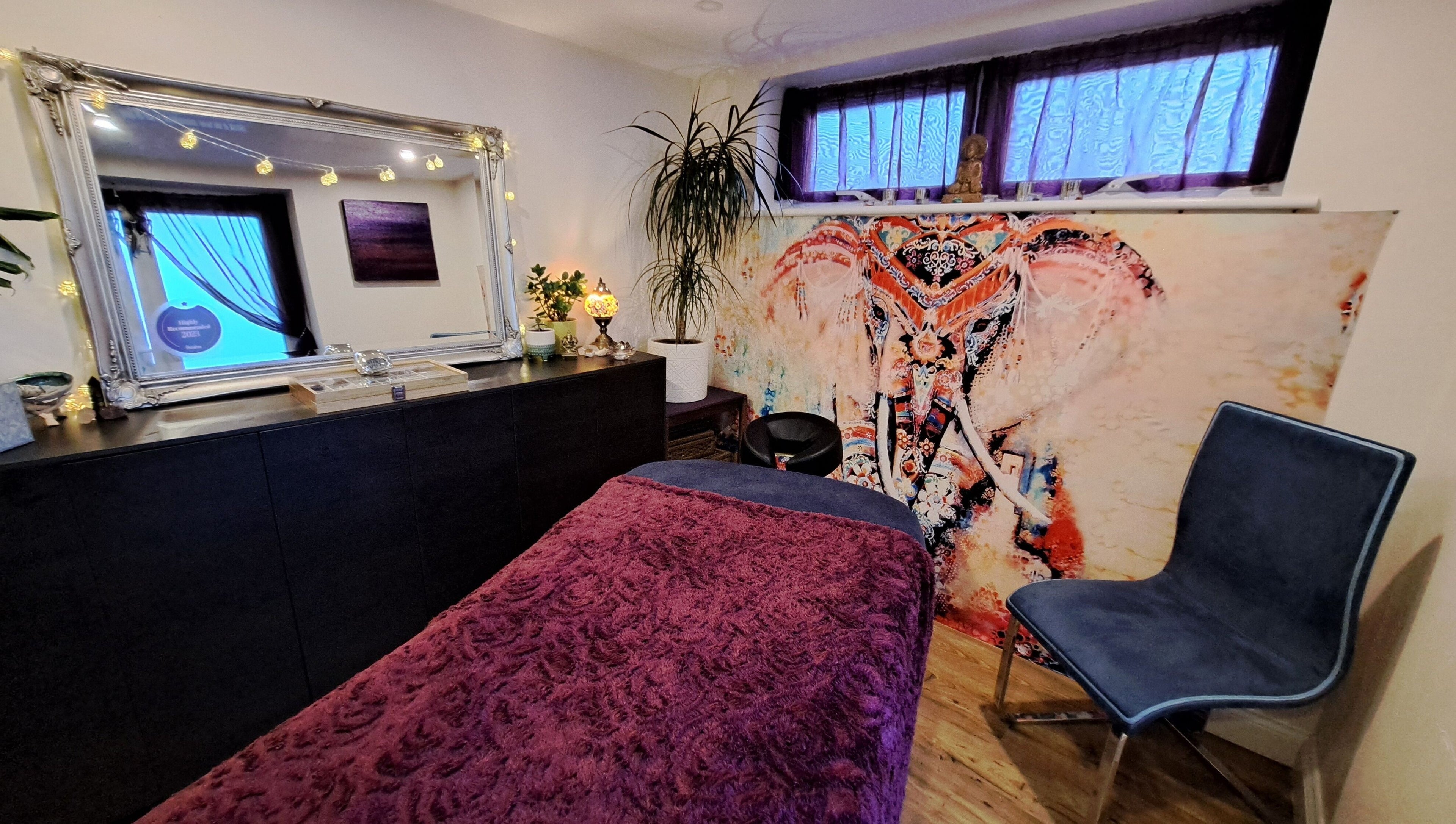 Vibrant treatment room at Tranquil Space Holistic Treatments in Bristol, GB with artistic elephant decor.