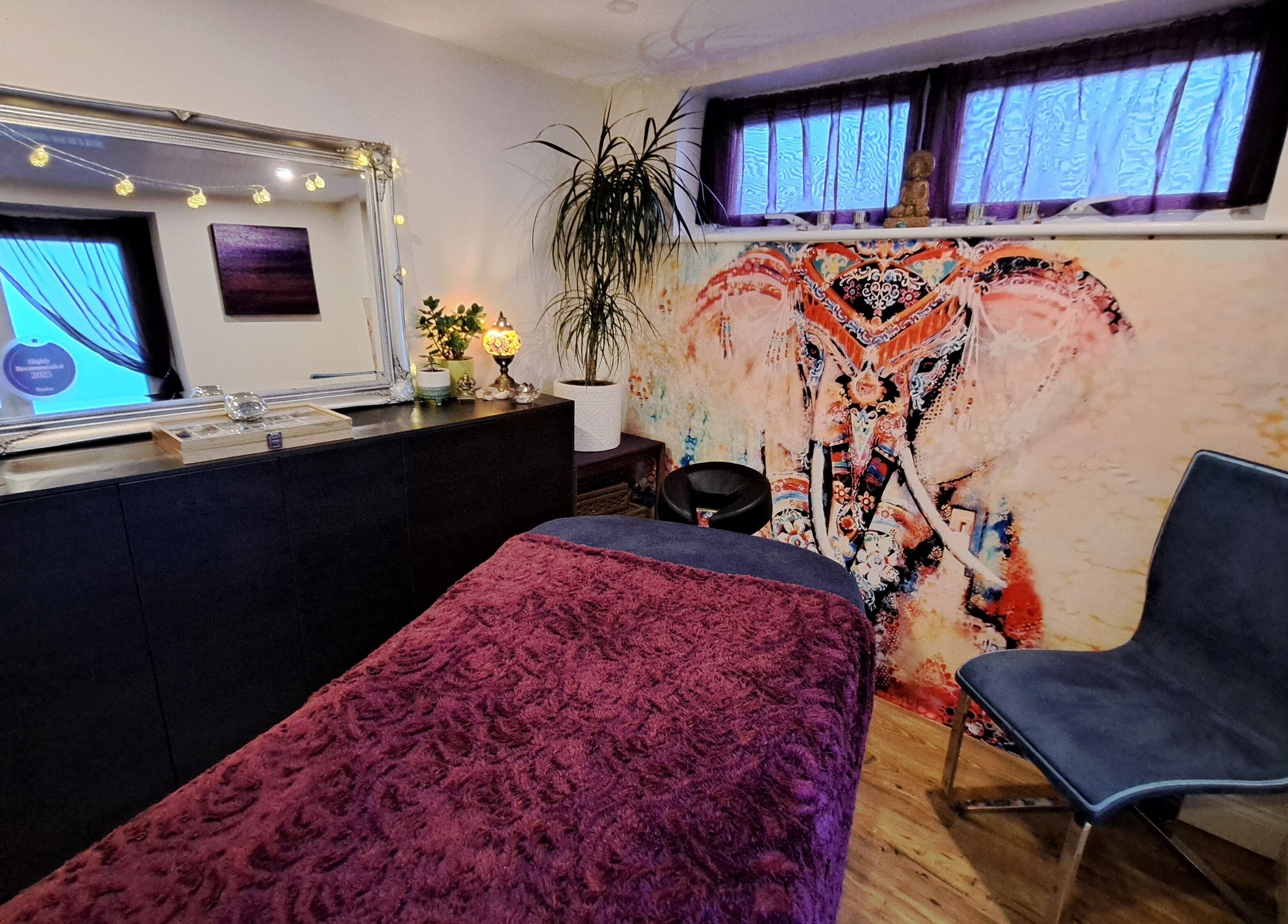 Vibrant treatment room at Tranquil Space Holistic Treatments in Bristol, GB with artistic elephant decor.