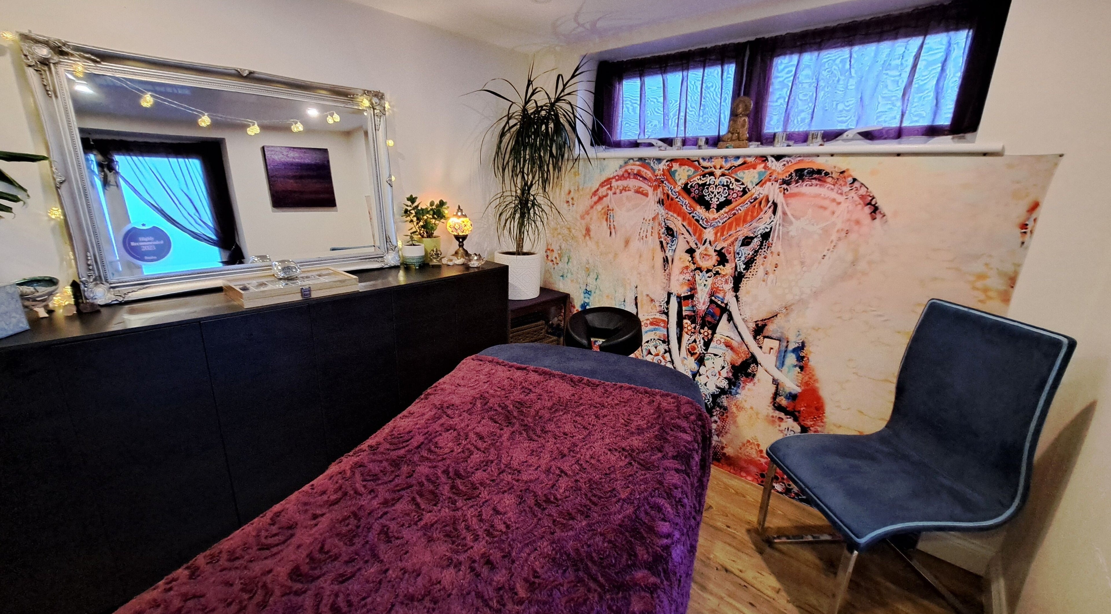 Vibrant treatment room at Tranquil Space Holistic Treatments in Bristol, GB with artistic elephant decor.