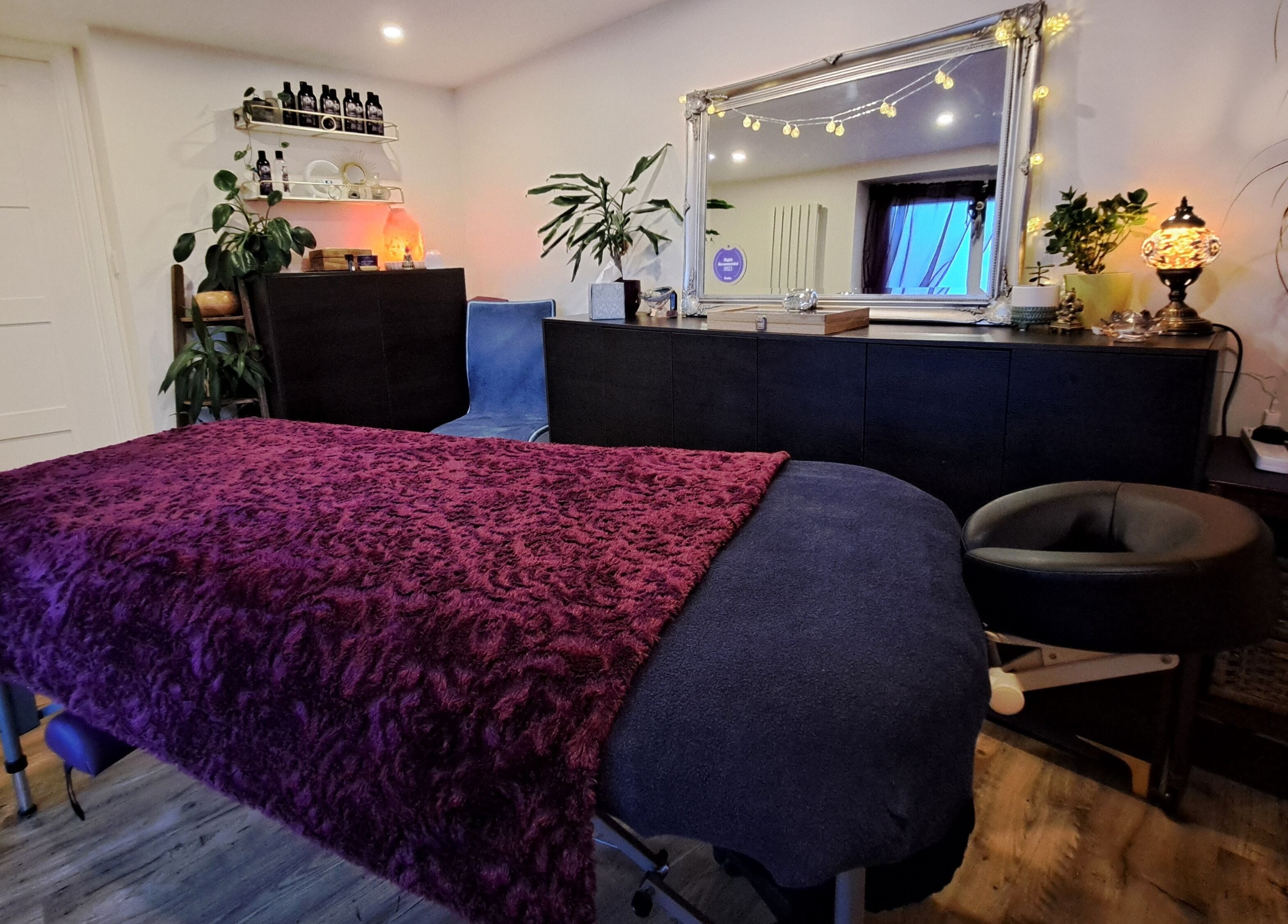 Relaxing treatment room at Tranquil Space Holistic Treatments in Bristol, GB with ambient lighting and cozy decor.