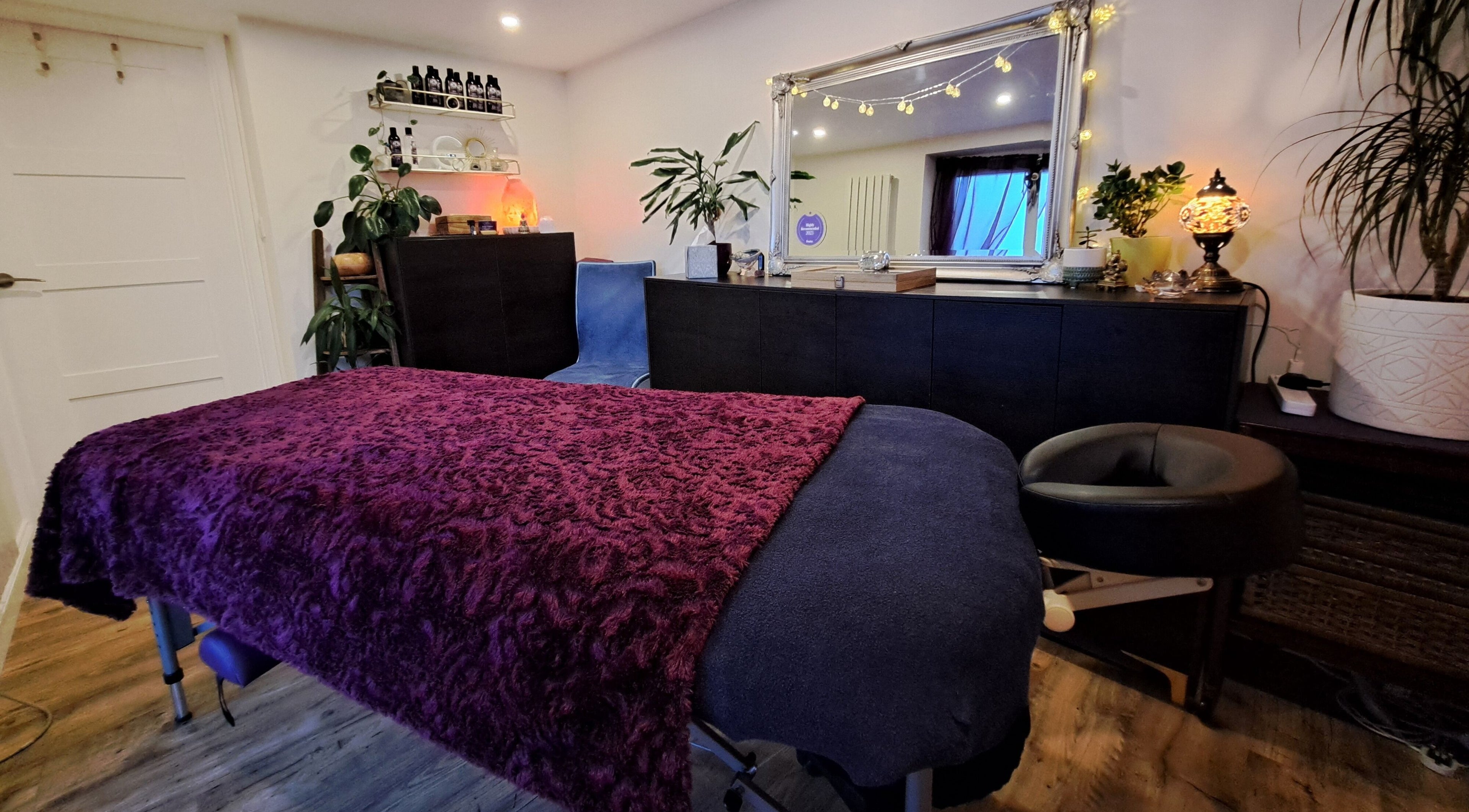 Relaxing treatment room at Tranquil Space Holistic Treatments in Bristol, GB with ambient lighting and cozy decor.