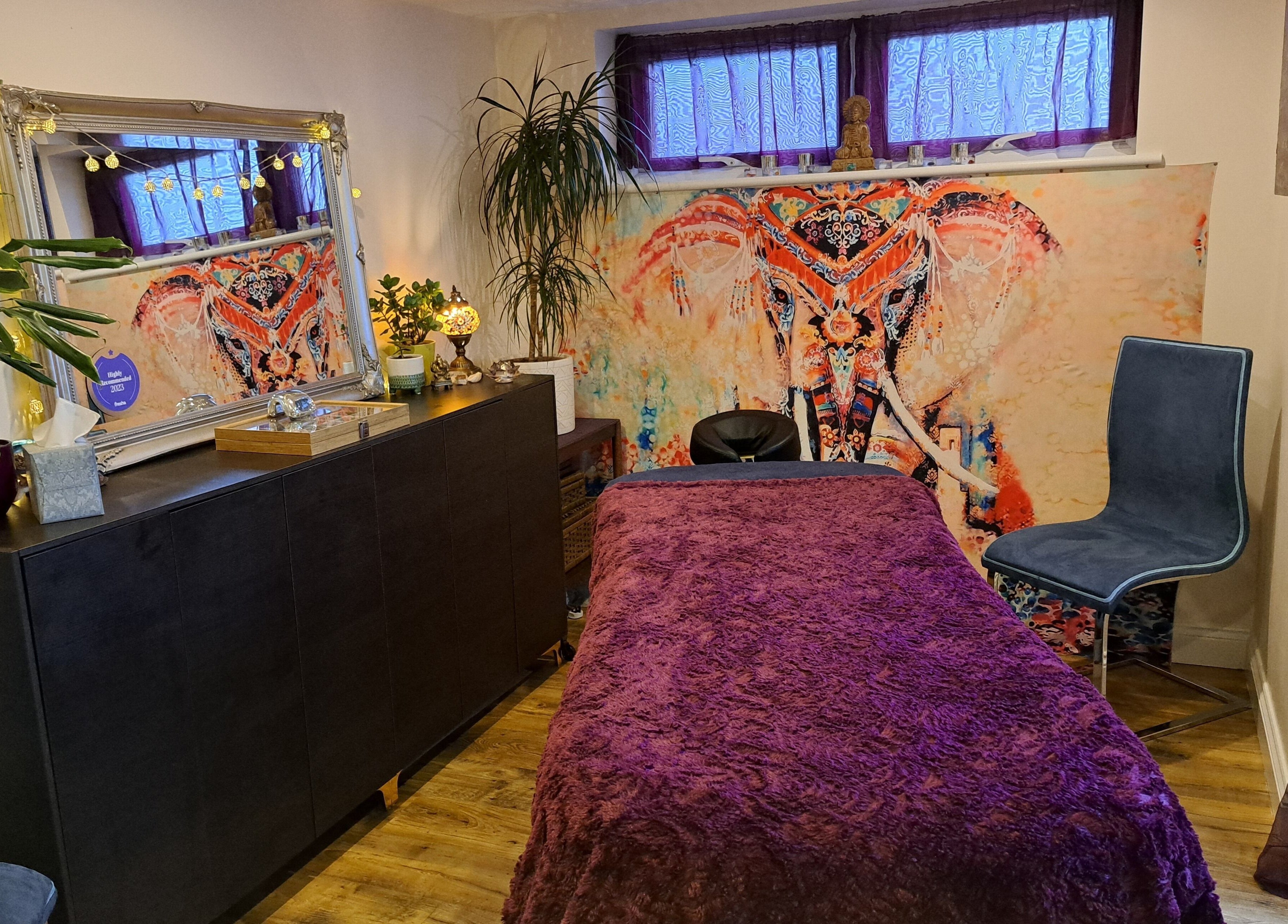Inviting treatment room at Tranquil Space Holistic Treatments, Bristol, GB, featuring cozy decor and elephant art.