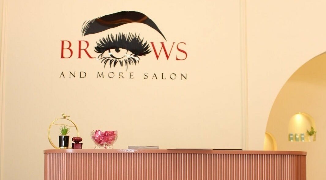 Reception area at Brows and More Salon, Dubai, with elegant decor and logo on display.