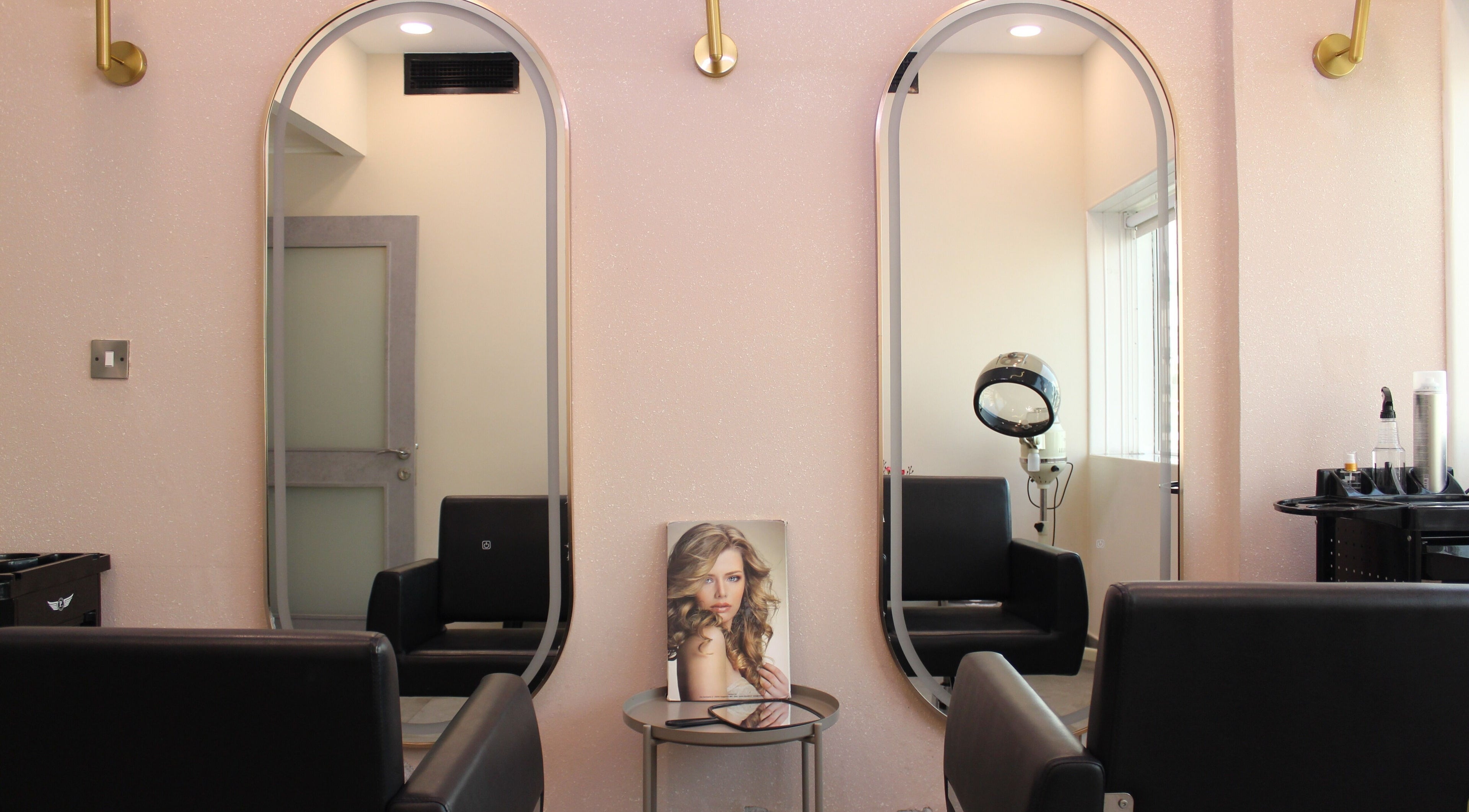 Elegant salon interior at Brows and More (Karama), Dubai. Features chic mirrors, seating, and styling tools.