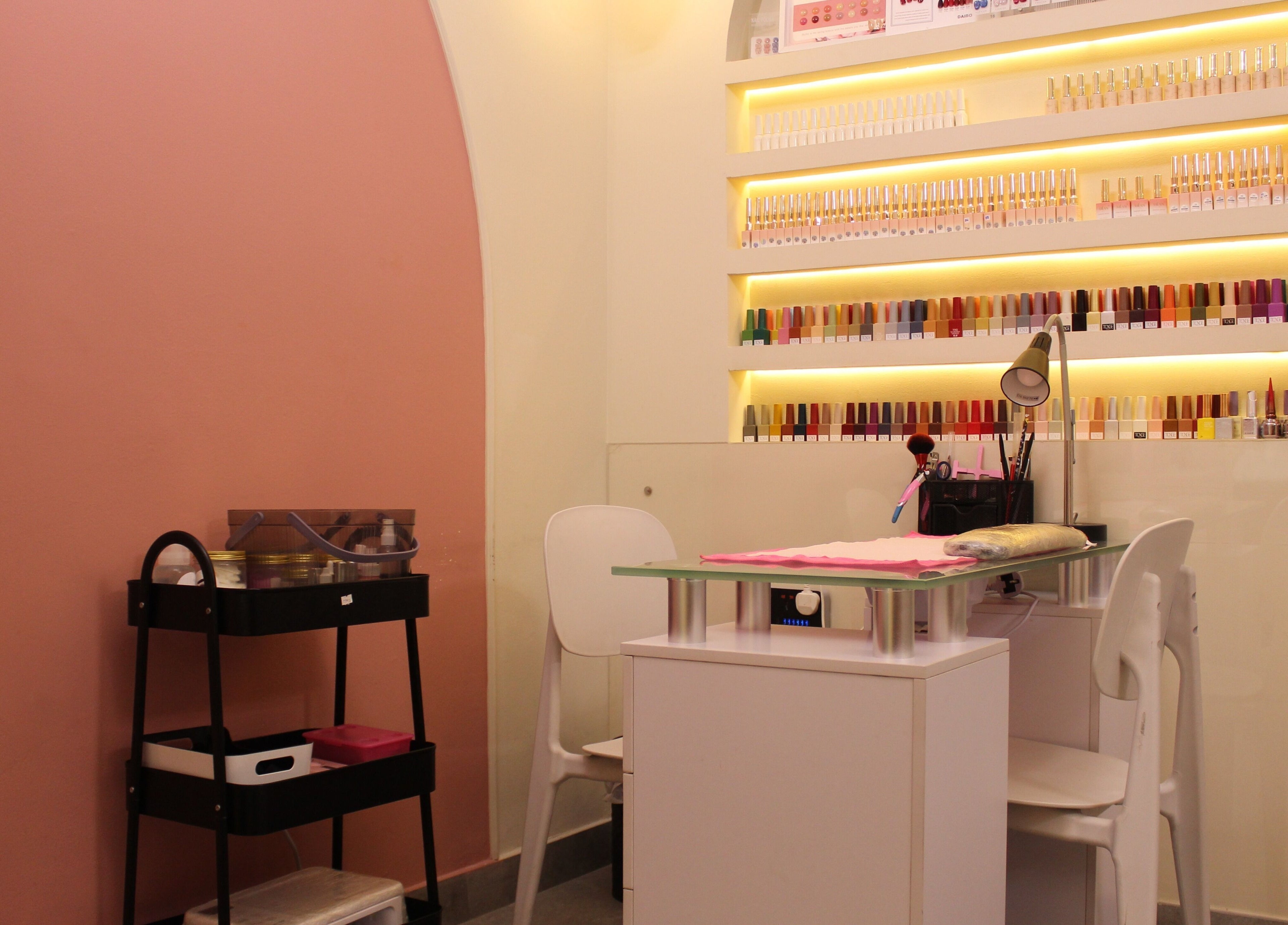 Stylish nail salon station at Brows and More (Karama) in Dubai, Dubai, AE with vibrant polish display.