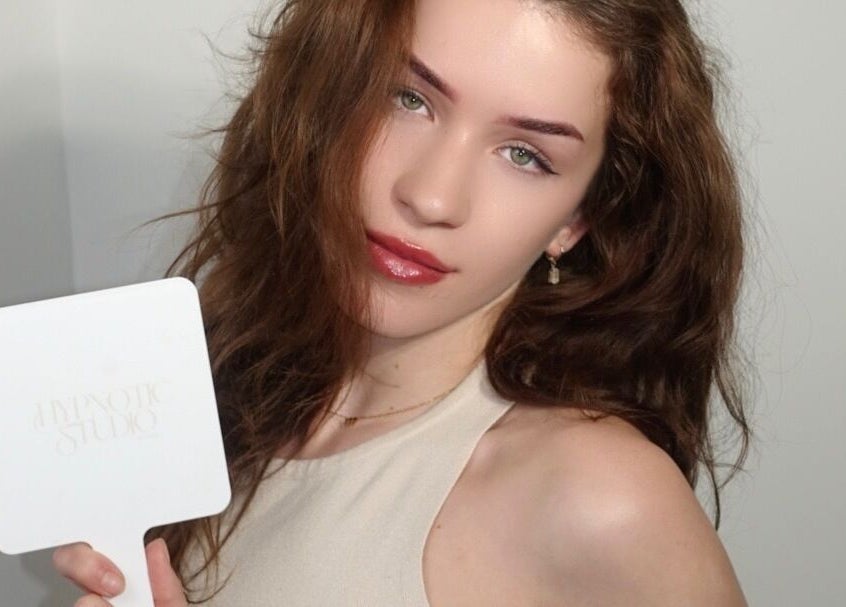 Client with styled brows holding Hypnotic Studio mirror at Lash & Brow Studio—Flinders Lane, Melbourne, Victoria, AU.