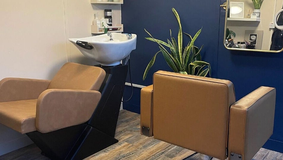 Modern salon setup at My Space se in Whitstable, England, GB featuring sleek chairs and a vibrant plant.