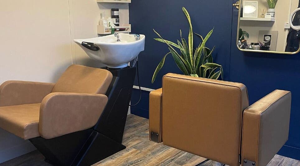 Modern salon setup at My Space se in Whitstable, England, GB featuring sleek chairs and a vibrant plant.