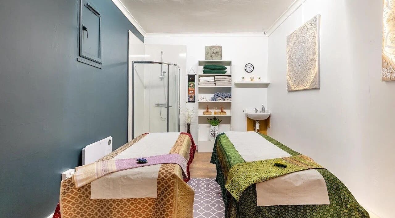 Relaxing massage room at Bodhi Tree Thai Massage, London, England, GB with twin tables and calming decor.