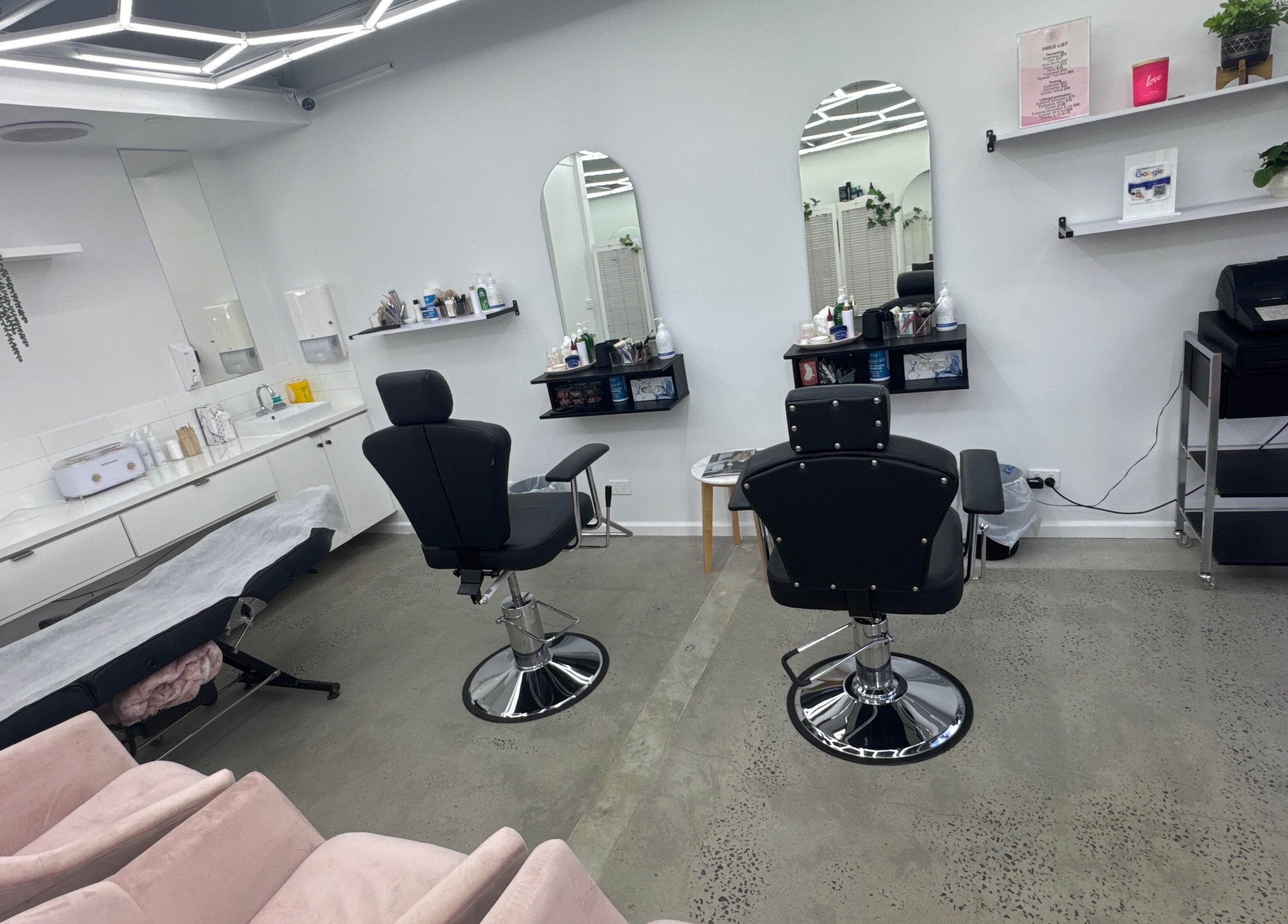 Bright interior of Brows by Sonia in Melbourne, Victoria, AU, showcasing sleek chairs and a modern aesthetic.