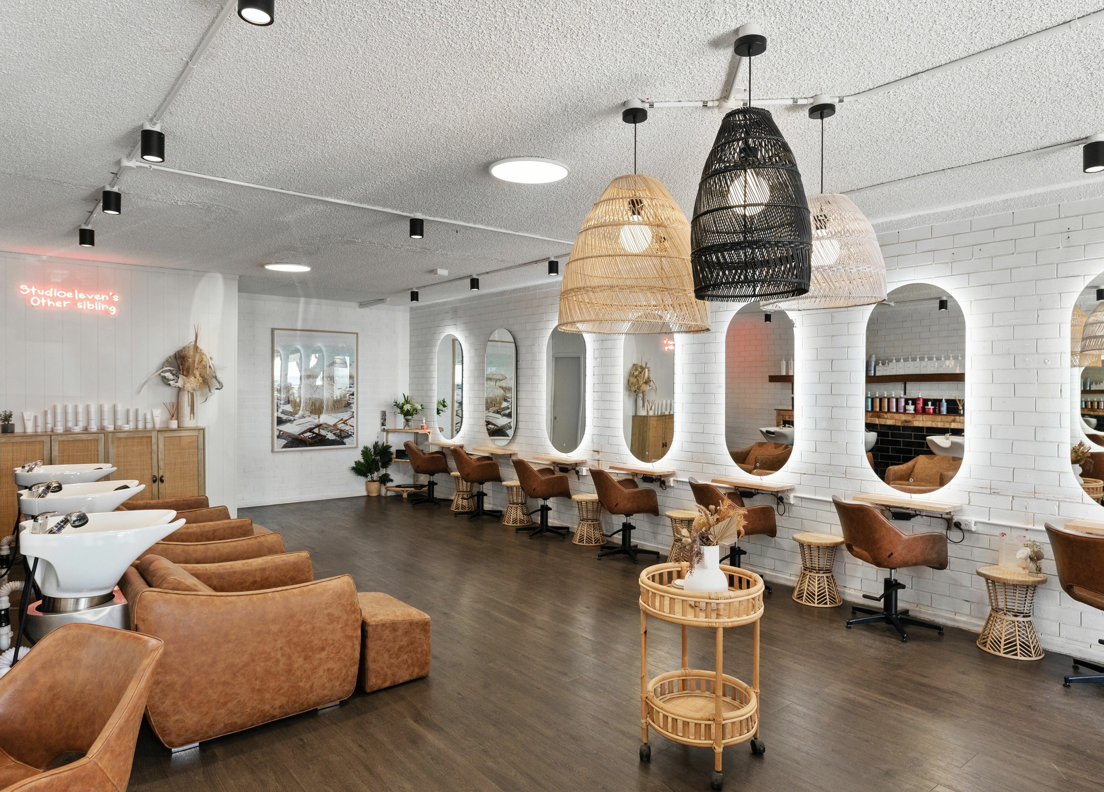 Stylish interior of Studio Eleven - Kingscliff with modern chairs and mirrors, Kingscliff, New South Wales, AU.