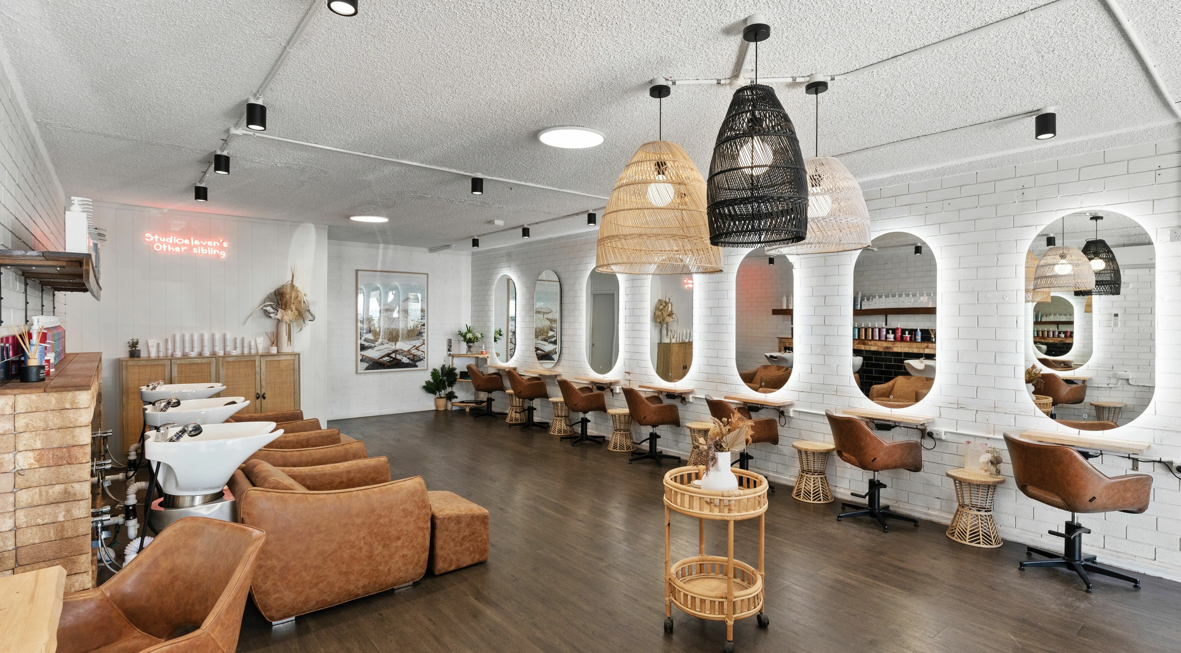 Stylish interior of Studio Eleven - Kingscliff with modern chairs and mirrors, Kingscliff, New South Wales, AU.