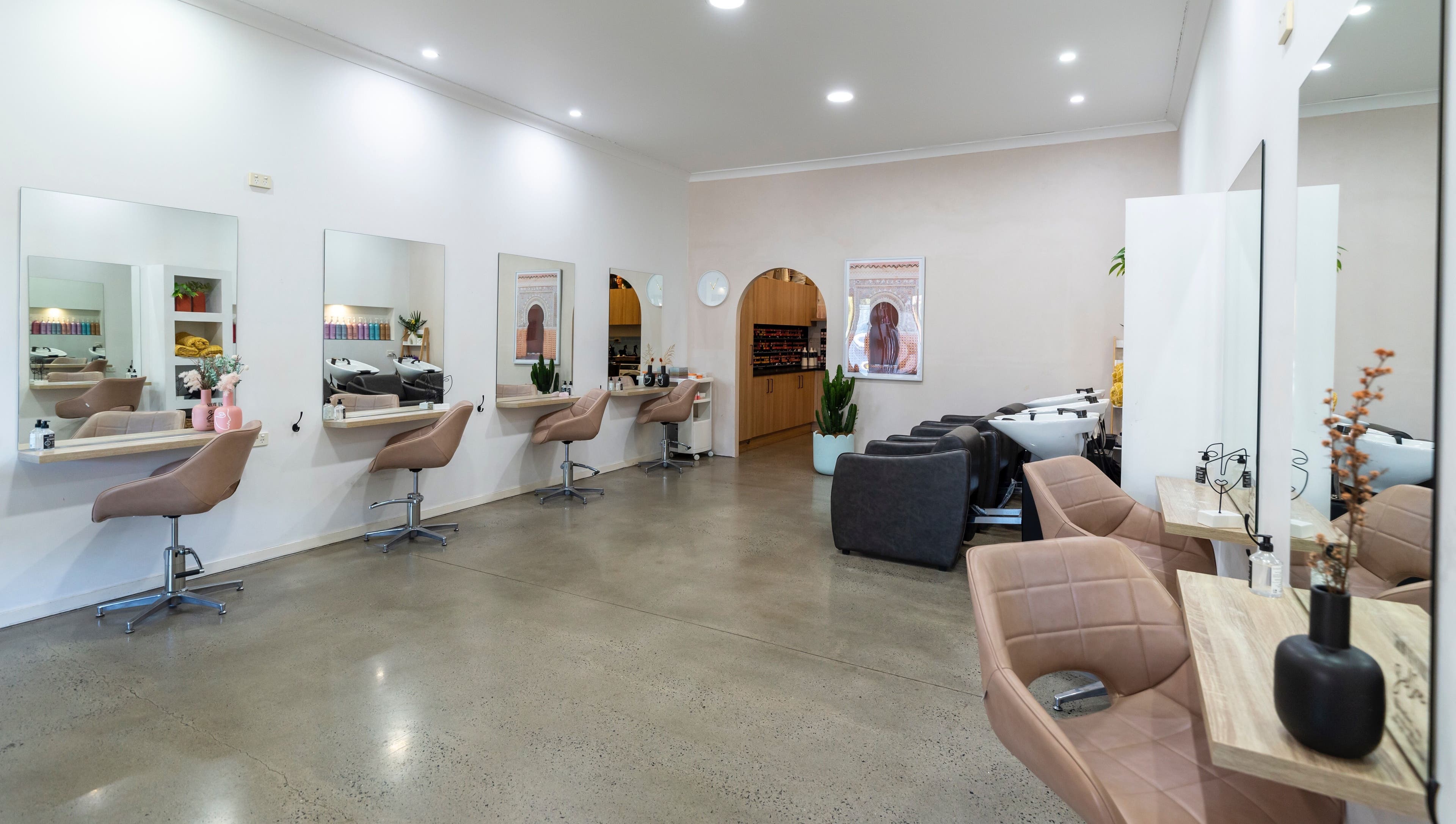 Modern styling area at Studio Eleven - Banora Point, showcasing chic salon chairs and mirrors in Banora Point, NSW.