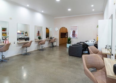 Modern styling area at Studio Eleven - Banora Point, showcasing chic salon chairs and mirrors in Banora Point, NSW.