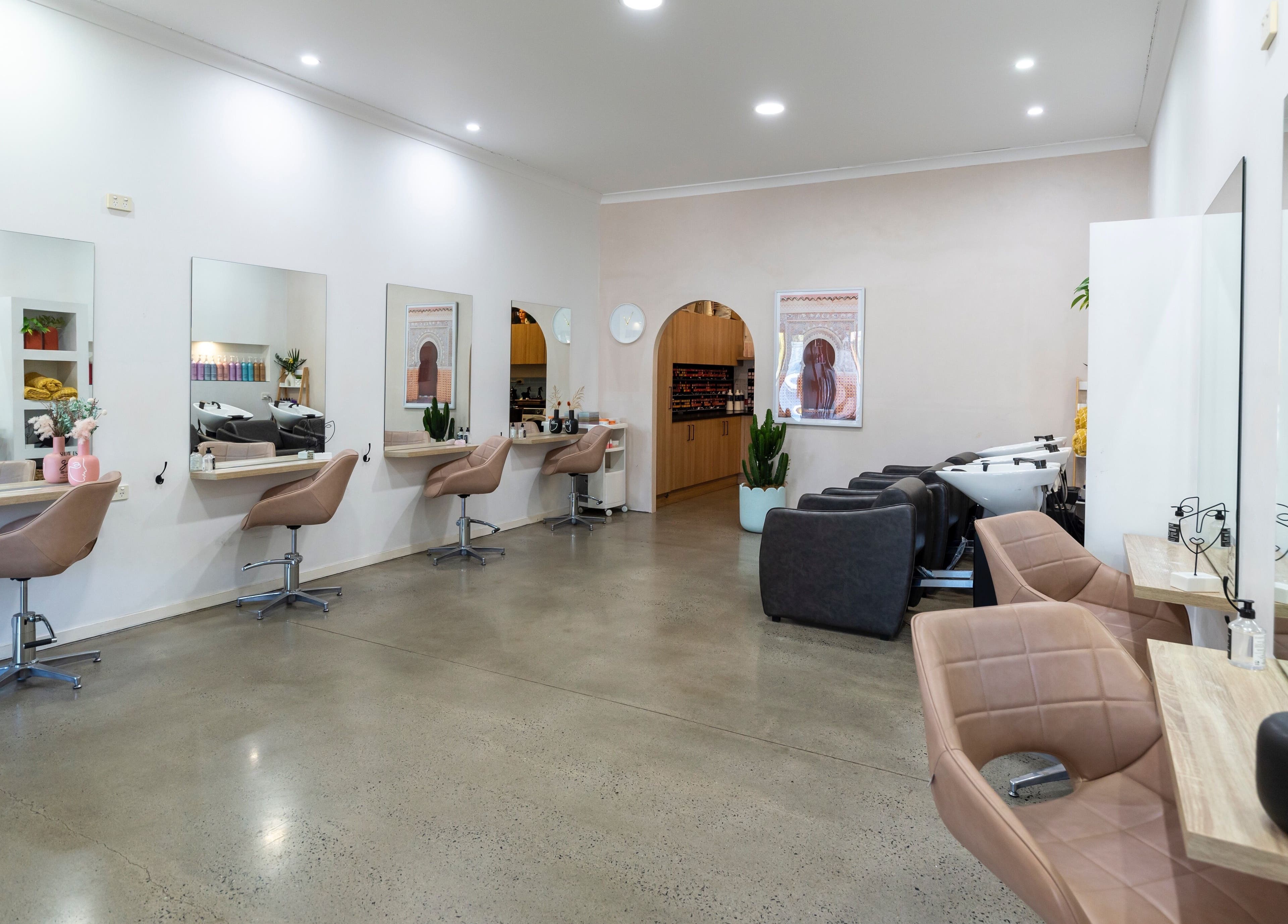 Modern styling area at Studio Eleven - Banora Point, showcasing chic salon chairs and mirrors in Banora Point, NSW.