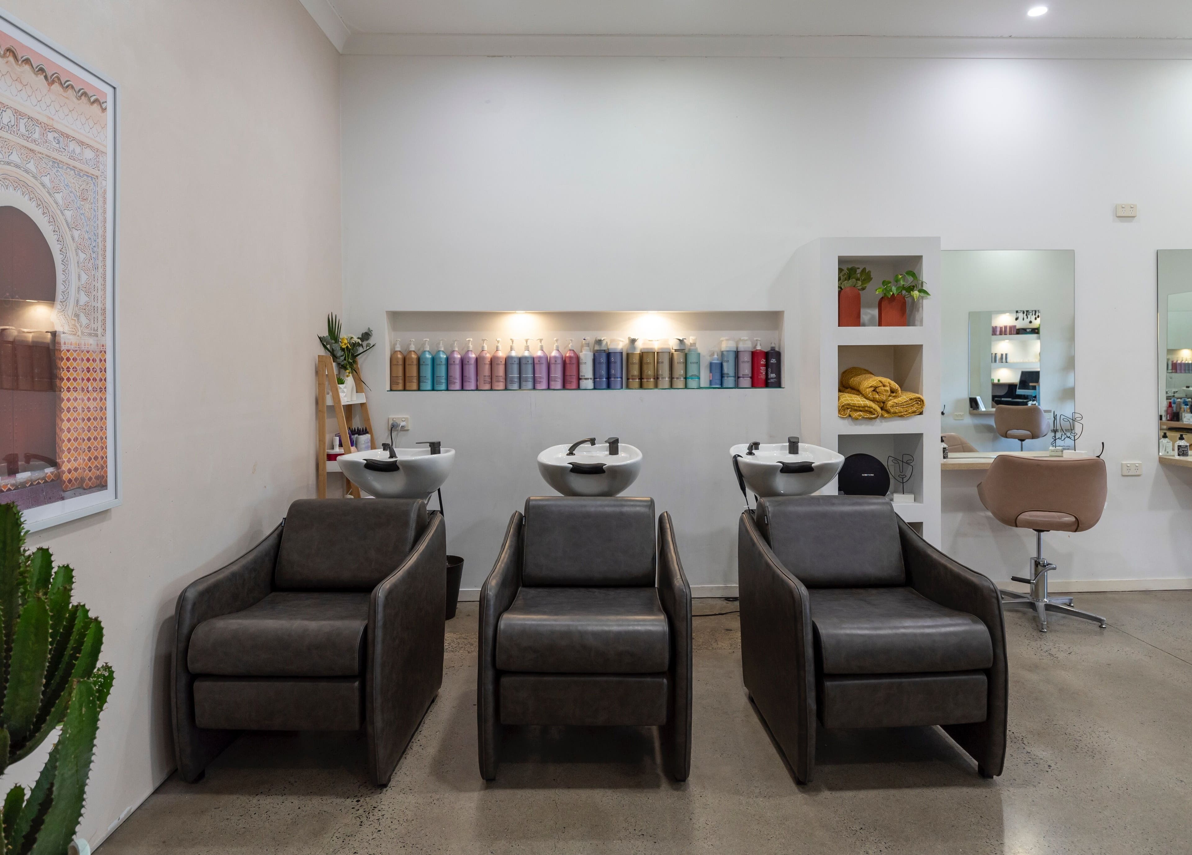 Modern interior of Studio Eleven - Banora Point with sleek salon chairs, mirrors, and product display in Banora Point, New South Wales, AU.
