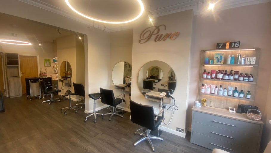 Chic and modern setup of Pure Hair Design, Ilkley, England, GB with stylish chairs and products.