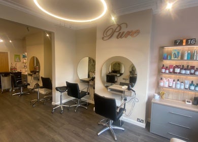 Chic and modern setup of Pure Hair Design, Ilkley, England, GB with stylish chairs and products.
