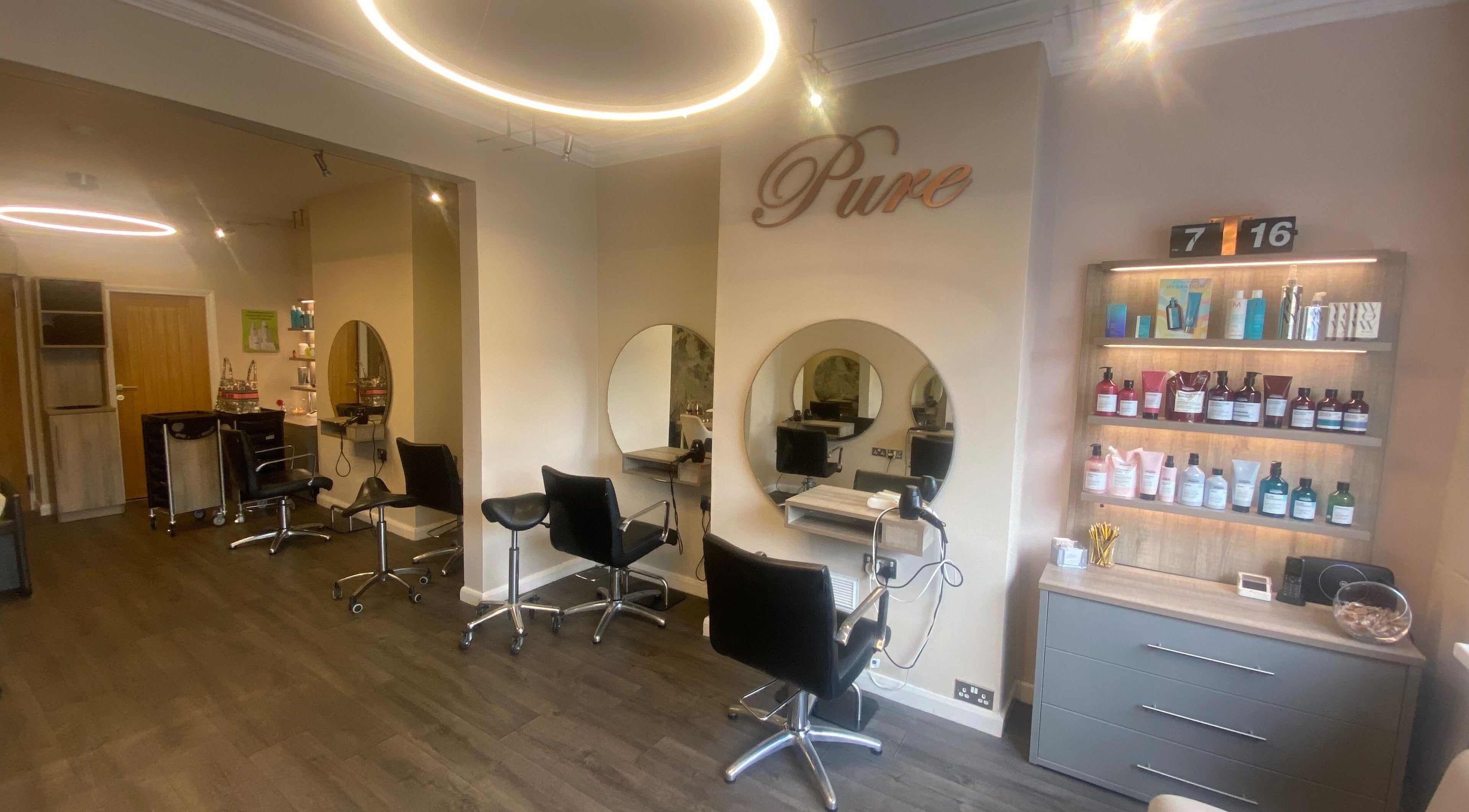 Chic and modern setup of Pure Hair Design, Ilkley, England, GB with stylish chairs and products.