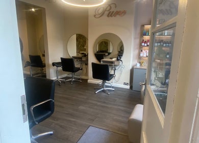 Modern salon chairs and mirrors at Pure Hair Design in Ilkley, England, GB.