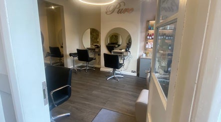 Modern salon chairs and mirrors at Pure Hair Design in Ilkley, England, GB.