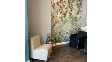 Cozy seating area with floral decor in Pure Hair Design, Ilkley, England, GB.