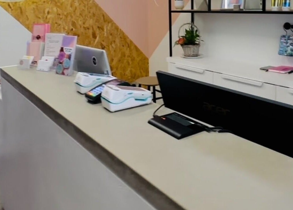 Reception desk at Solarium Point in Ramsgate, England, GB with modern decor and vibrant colors.