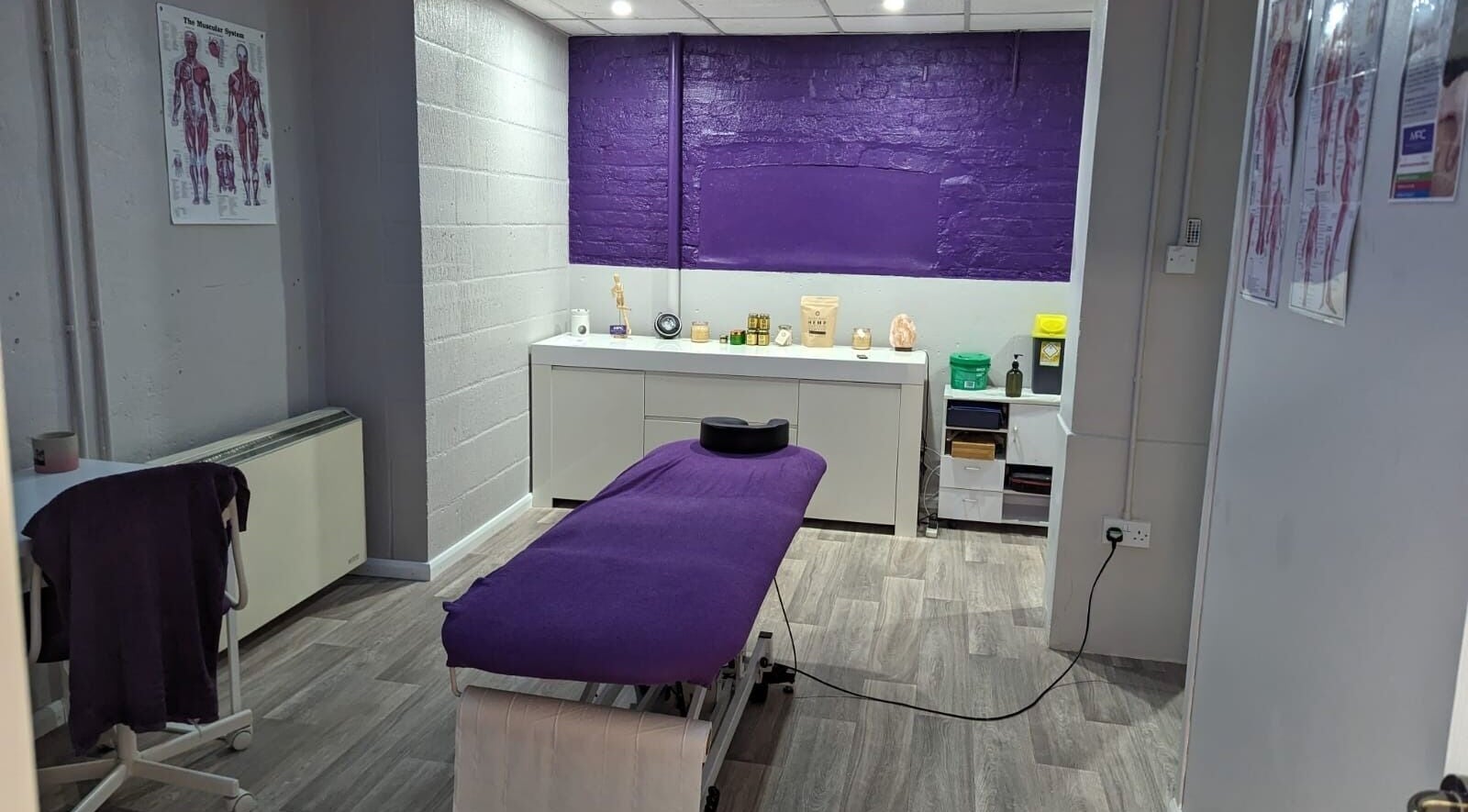 Relaxing treatment room at Muscle Performance Clinic, Burgess Hill, England, GB with massage bed and decor.