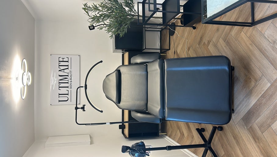 Luxury treatment room at Ultimate Skin and Beauty - Kent, Bexleyheath, England, with a stylish black chair.