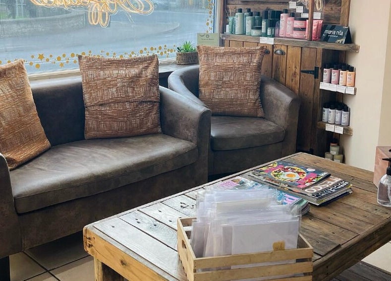 Inviting lounge area in Cocoa Hair Design, Keynsham, England, GB, featuring plush seating and stylish decor.