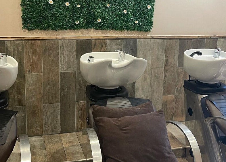Hair wash stations at Cocoa Hair Design, Keynsham, England, GB, featuring modern basins and green decor.