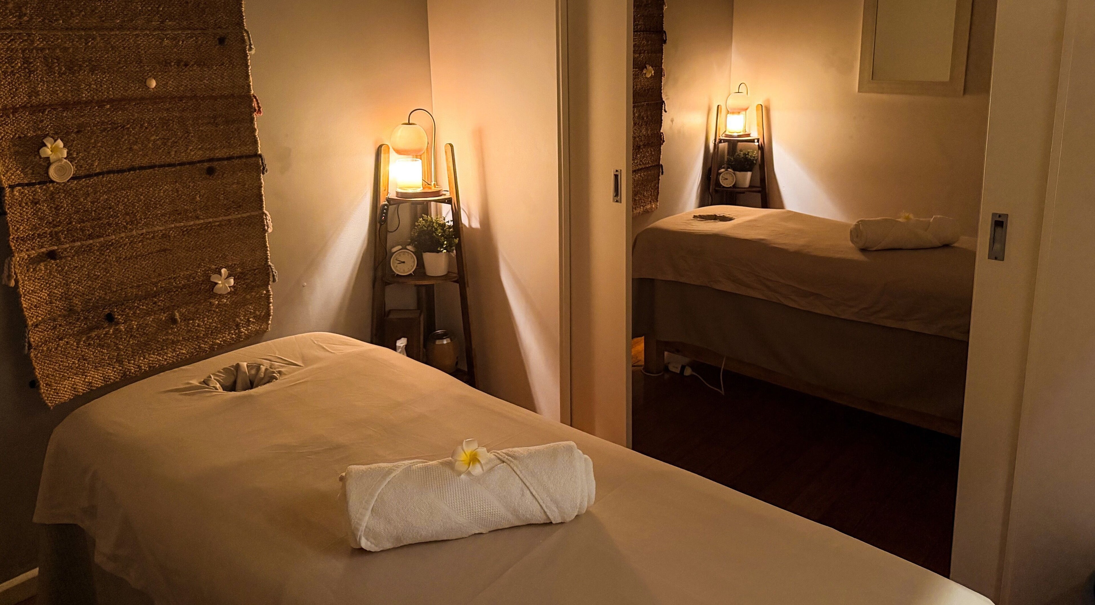 Relaxing massage room at Natural Thai Massage & Skincare, Melbourne, Victoria, AU with warm lighting and decor.