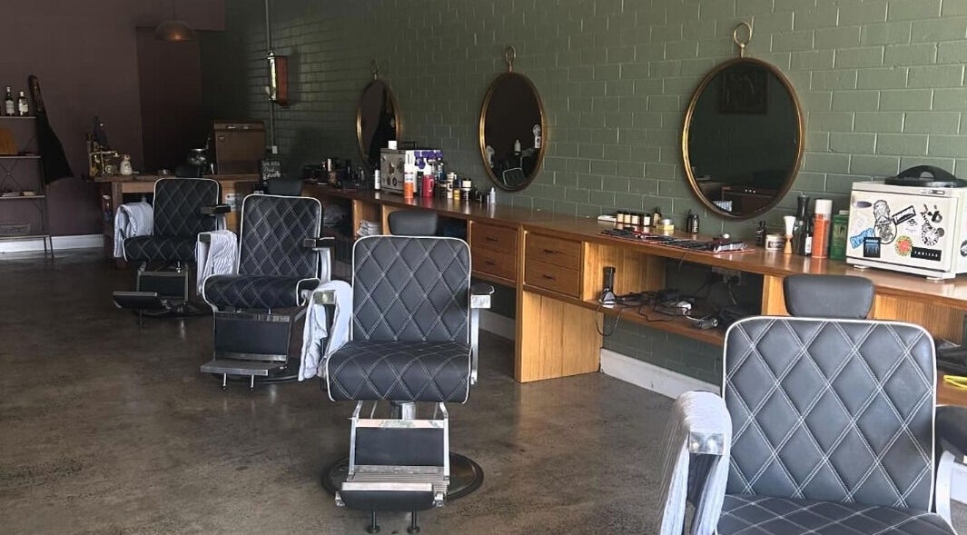 Interior of St Martins Barber Shop, Diamond Creek, Victoria, AU, featuring vintage barber chairs and large mirrors.